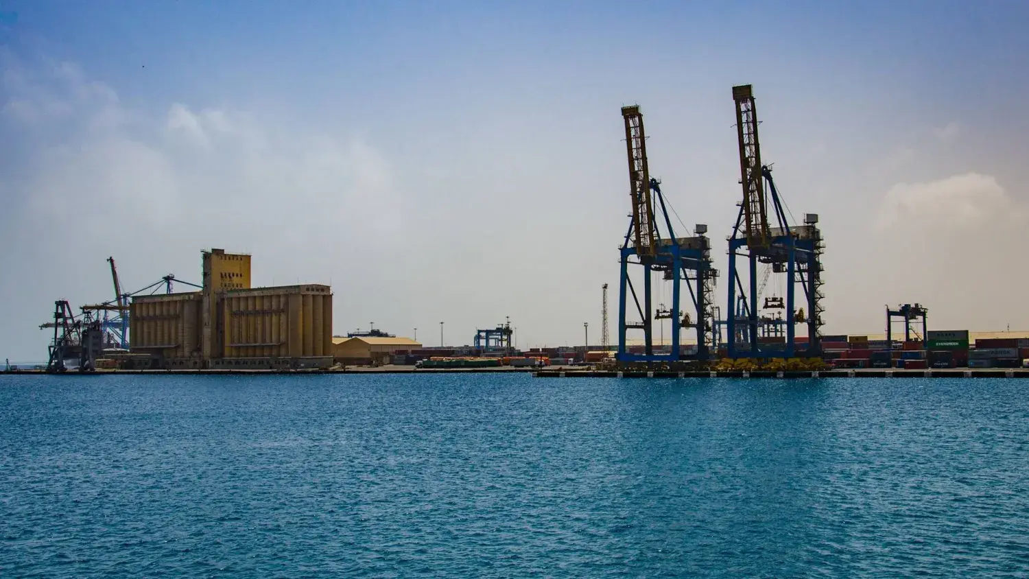 Port Sudan container yard with cargo cranes and organized shipping containers for ACD processing